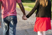 Rear view of mid adult couple holding hands — Stock Photo