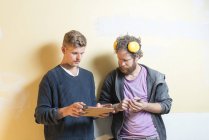 Friends using digital tablet during renovation, selective focus — Stock Photo