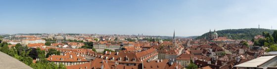 Prague city buildings roofs under blue sky — Stock Photo
