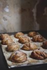 Table with fresh baked cardamon buns — Stock Photo