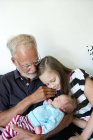 Grandfather and granddaughter with newborn baby girl — Stock Photo