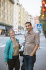 Portrait of smiling couple standing on street — Stock Photo