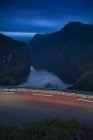 Still river with road and light trails, long exposure — Stock Photo