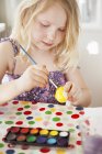Дівчина малює яйце, вибірковий фокус — стокове фото