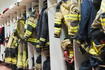 Fire station changing cubicles with firefighters uniform — Stock Photo