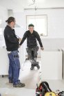 Carpenters having break in furniture installation, selective focus — Stock Photo