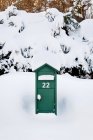 Vorderseite des grünen Briefkastens mit Schnee bedeckt — Stockfoto