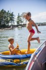 Boys playing in inflatable raft, differential focus — Stock Photo