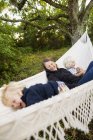 Grandmother and grandchildren in hammock, differential focus — Stock Photo