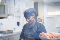 Woman in cafe kitchen, differential focus — Stock Photo