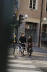 Dos jóvenes de pie en bicicleta, enfoque selectivo - foto de stock