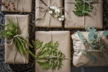 Top view of wrapped Christmas presents with twigs — Stock Photo