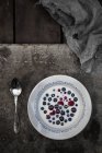 Top view of berries in milk on plate — Stock Photo