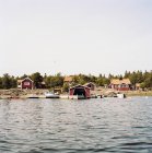 Village harbor and falu red waterfront houses — Stock Photo