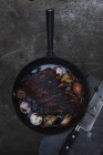 Top view of frying pan with baked ribs — Stock Photo