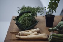 Herbs and vegetables on wooden table, still life — Stock Photo