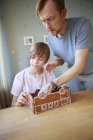 Father and son making cookie bus, focus on foreground — Stock Photo