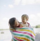 Mother and daughter wrapped in towel, focus on foreground — Stock Photo