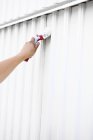 Hand painting wall in white color with brush — Stock Photo
