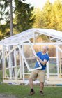 Man building greenhouse, selective focus — Stock Photo