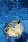 Woman and daughter holding ice lantern — Stock Photo