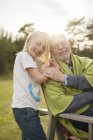 Portrait of grandfather with granddaughter in back yard — Stock Photo
