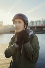 Retrato ao ar livre de homem adulto médio amarrando alça de capacete — Fotografia de Stock