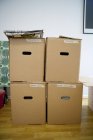 Front view of cardboard boxes stacked in room — Stock Photo
