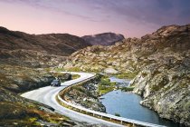 Auto guida lungo Trollstigen Road tortuoso accanto stretto fiordo — Foto stock