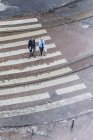 Elevated view of two people crossing street — Stock Photo