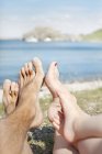 View of feet of three people, focus on foreground — Stock Photo
