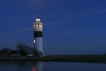 View of illuminated lighthouse and night sky — Stock Photo