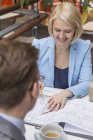 Businesswoman at meeting in cafe, differential focus — Stock Photo