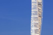 Illuminated skyscraper against blue sky — Stock Photo