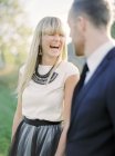 Portrait of laughing bride and groom, selective focus — Stock Photo