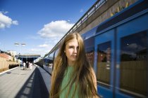 Portrait of teenage girl on railroad station platform — Stock Photo