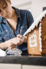 Woman making gingerbread house, differential focus — Stock Photo
