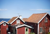 Falu red houses in sunlight on blue sky — Stock Photo