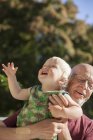 Boy playing with grandfather, focus on foreground — Stock Photo