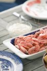 Dish of shrimps and sauce on wooden table — Stock Photo