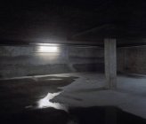 Empty underground car park with wet floor — Stock Photo