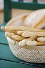 Close up shot of basket with fresh baked breadsticks — Stock Photo