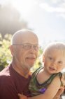 Portrait of boy with grandfather, focus on foreground — Stock Photo
