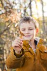 Boy showing chanterelle, focus on foreground — Stock Photo