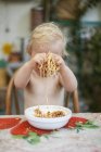 Boy playing with spaghetti, selective focus — Stock Photo