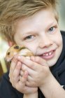 Portrait of boy playing with hamster, selective focus — Stock Photo