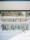 Collection of fishing tackles on wall, front view — Stock Photo