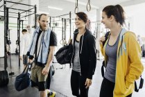 Young women and man laughing in gym — Stock Photo