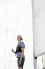 Side view of young man on sailboat — Stock Photo
