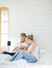 Father and mother holding baby boy in arms at bedroom — Stock Photo